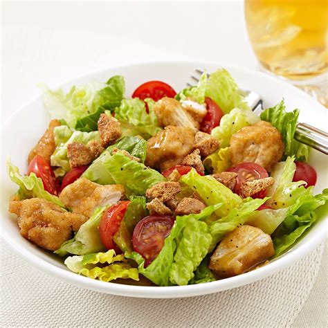 A food worker prepares chicken salad - Directions. In a large bowl, combine chicken, grapes, celery, onions and eggs. In another bowl, combine the next 9 ingredients; stir until smooth. Pour over the chicken mixture and toss gently. Stir in almonds and …